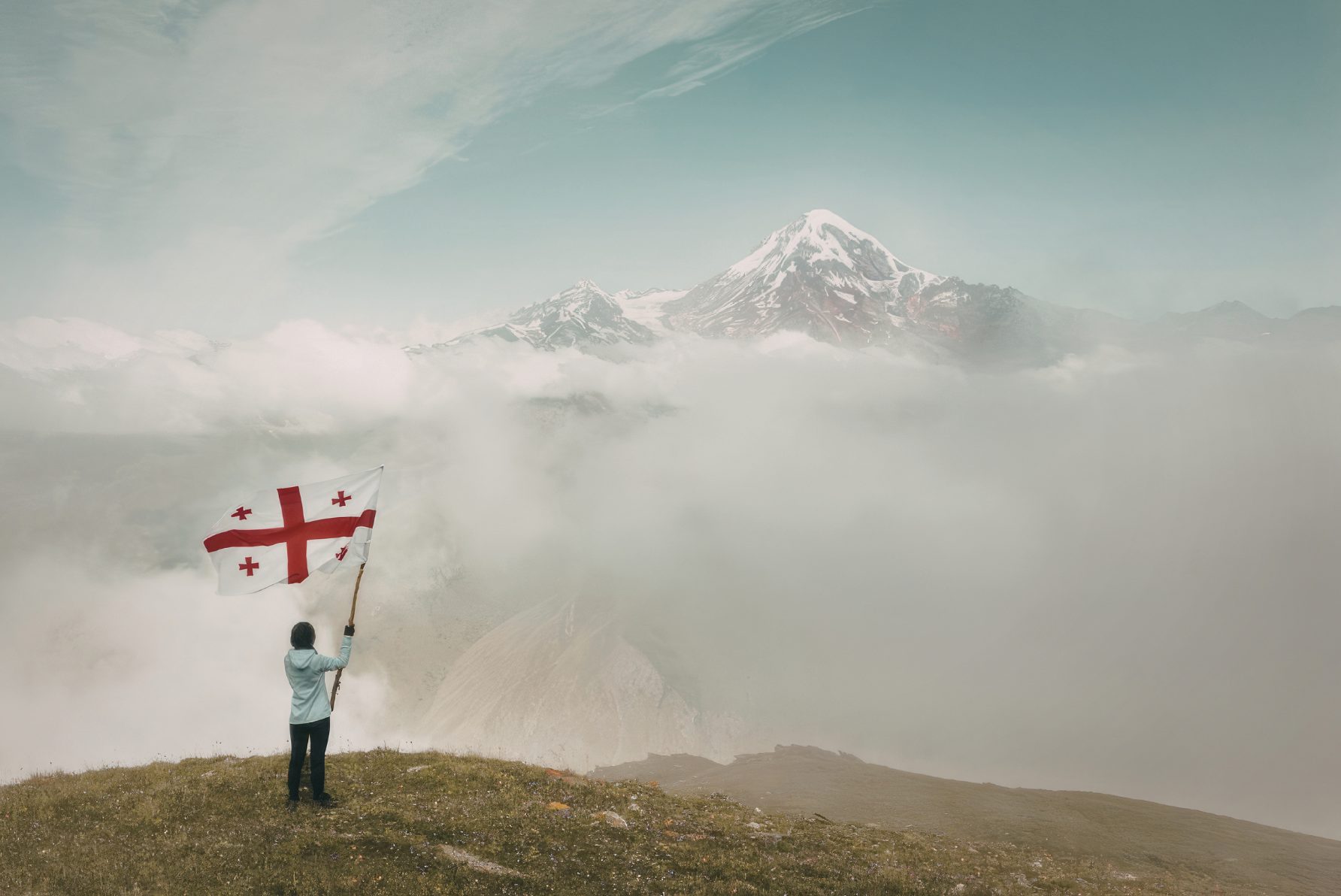 The Georgian flag raised before Mount Kazbek